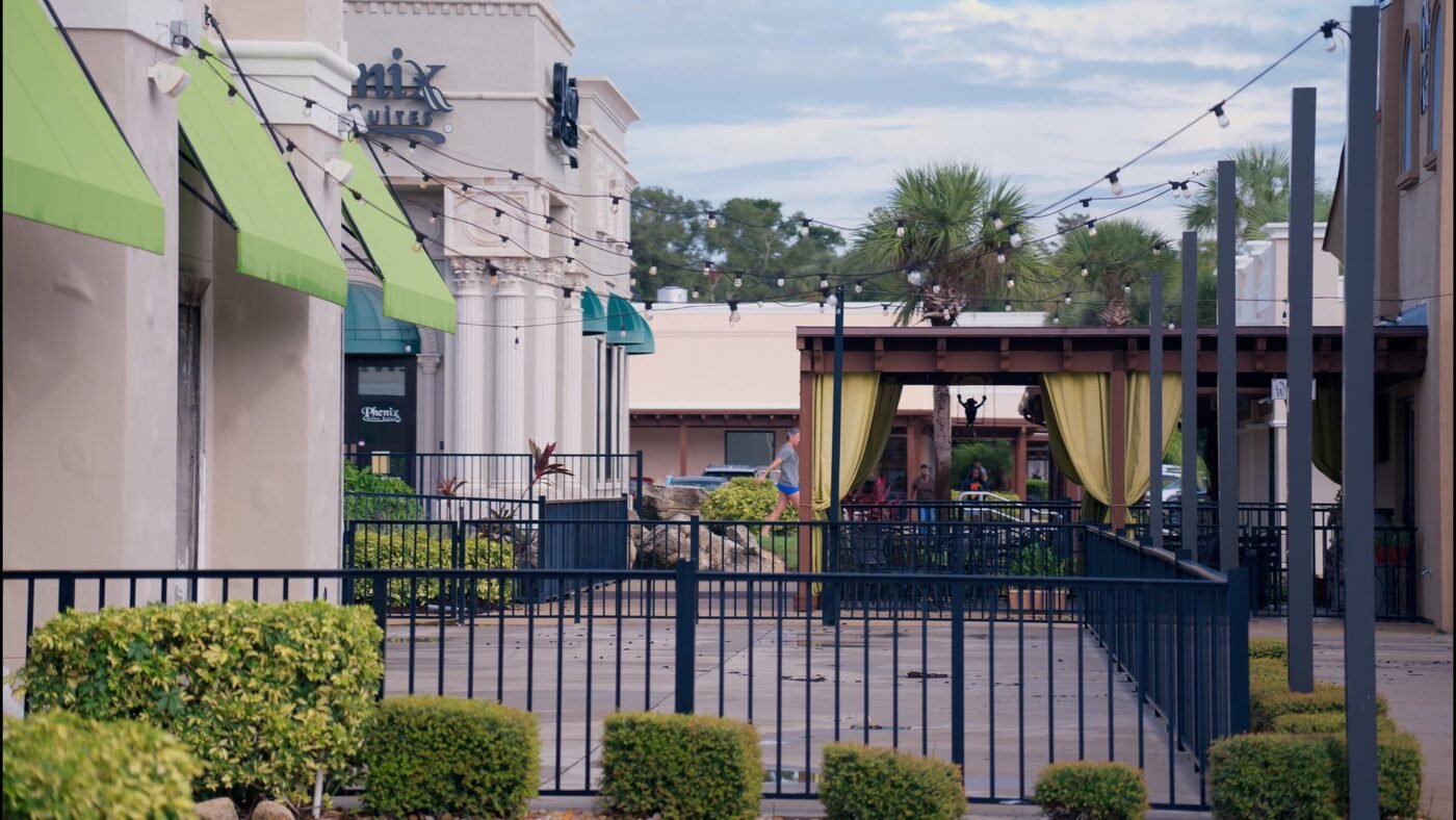 Central Florida commercial retail district with string lights and outdoor seating