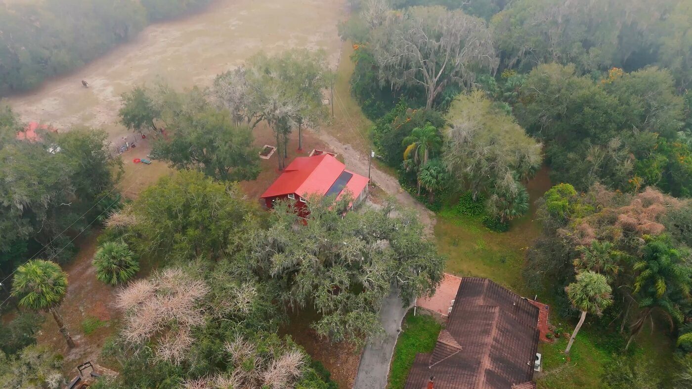 Aerial drone footage of a Central Florida property surrounded by oak trees