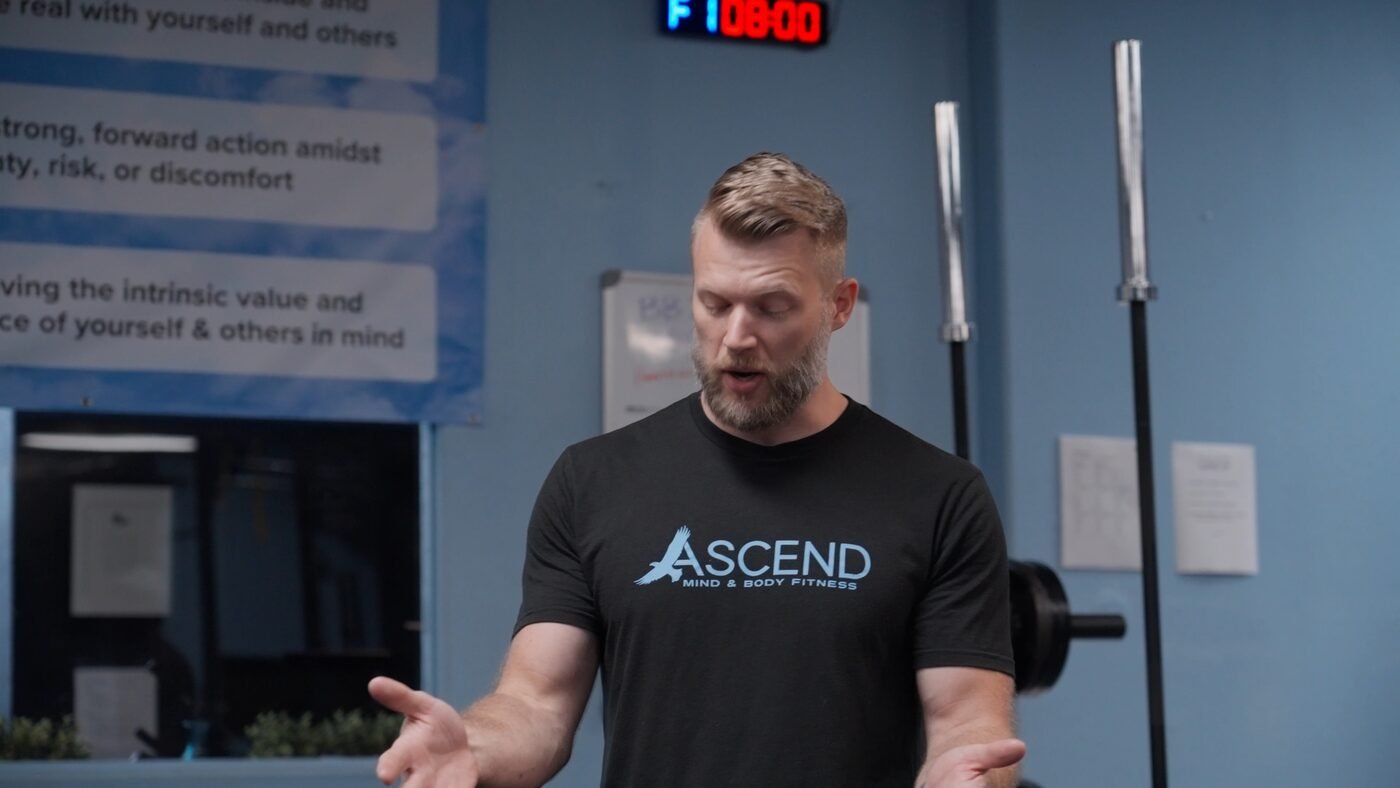 Fitness business owner speaking directly to camera in his gym