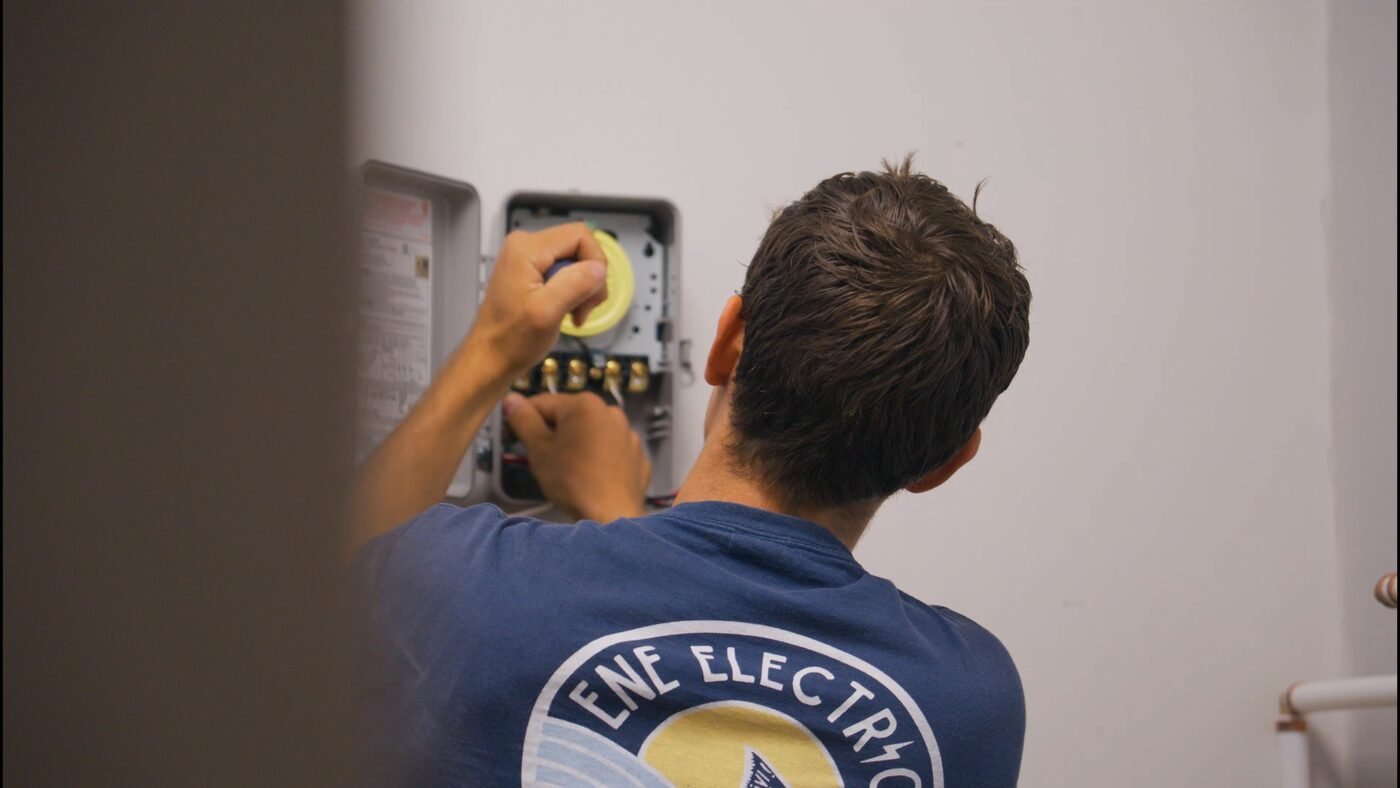 Electrician working on an electrical panel — trades business video content