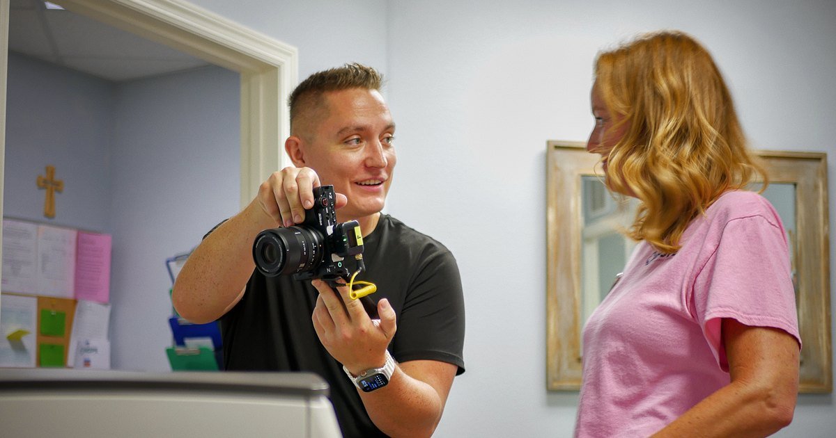 Nathan LaValley showing a client his camera